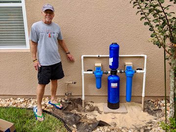 Homeowner with newly installed well water filtration system