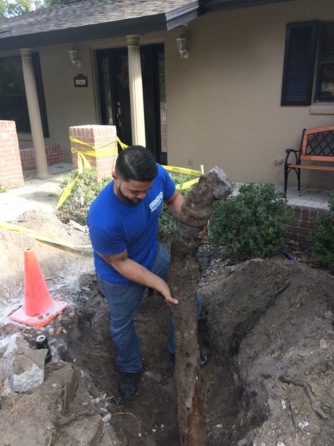 A badly corroded old cast iron sewer pipe pulled out of the ground