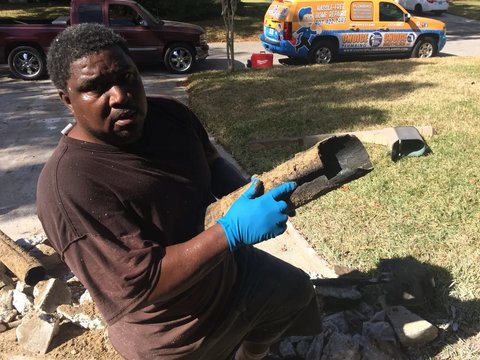 A crumbling section of old sewer pipe pulled from the trench