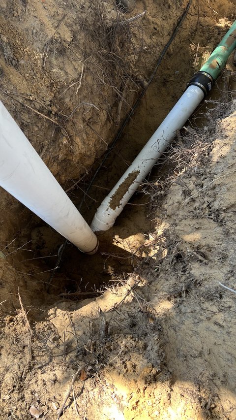 New white PVC sewer pipe section installed and coupled to the existing line by Choice Plumbing