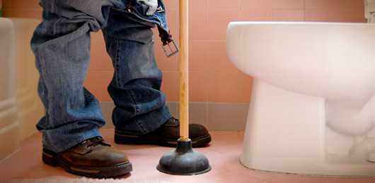 plunging a clogged toilet