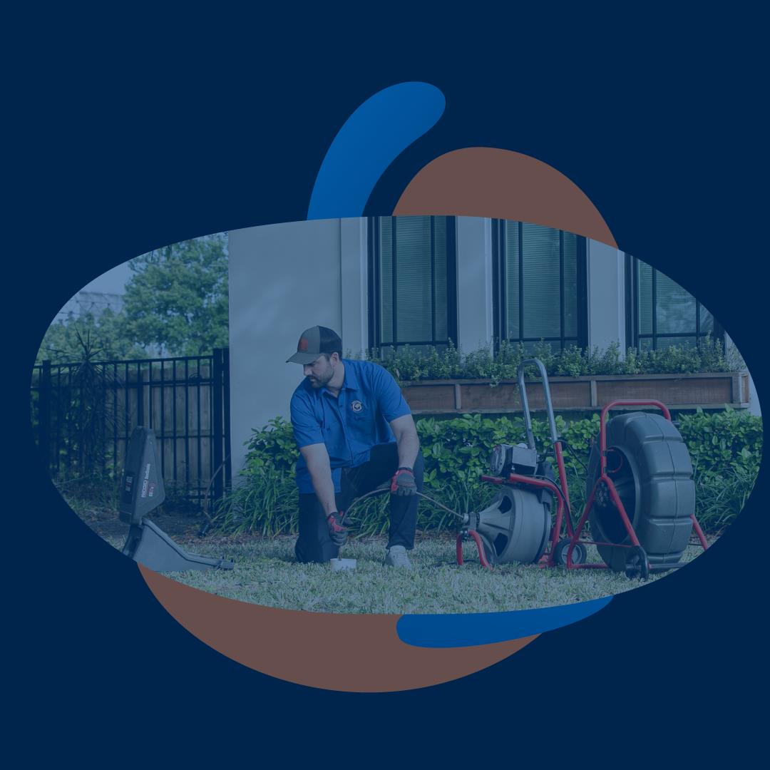 plumber cleaning a clogged drain