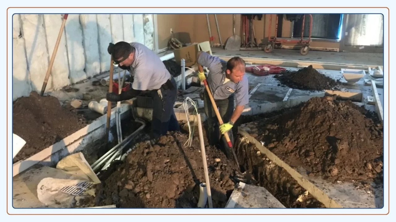 Plumbing team working on a damaged sewer drain pipe