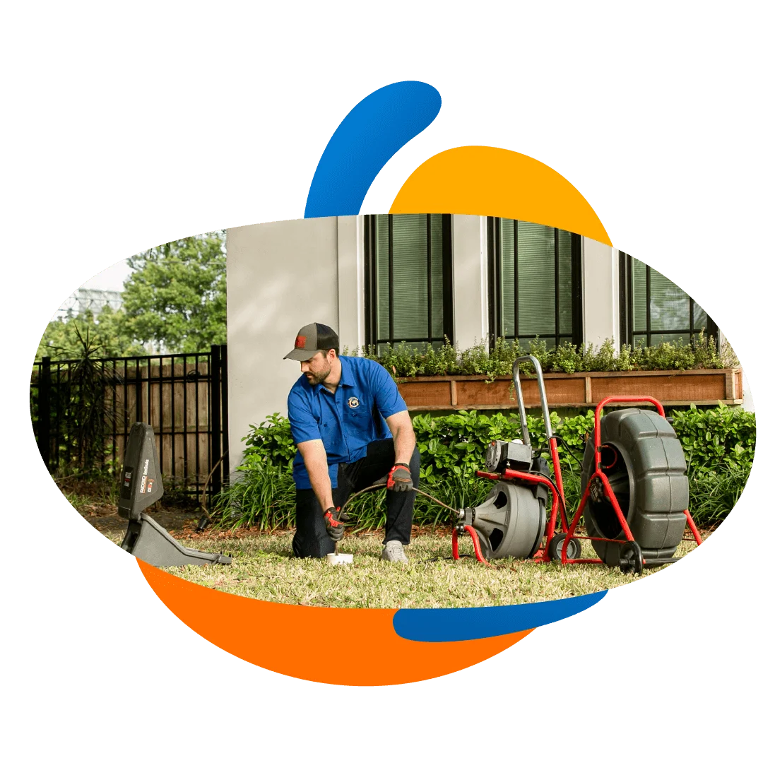 Plumber Unclogging a Drain Line