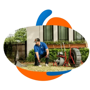 Plumber using a sewer machine to unclog a residential drain in Orlando, FL