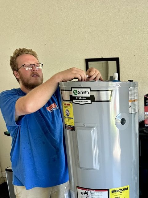 Plumber in Winter Garden FL preparing a new water heater for installation
